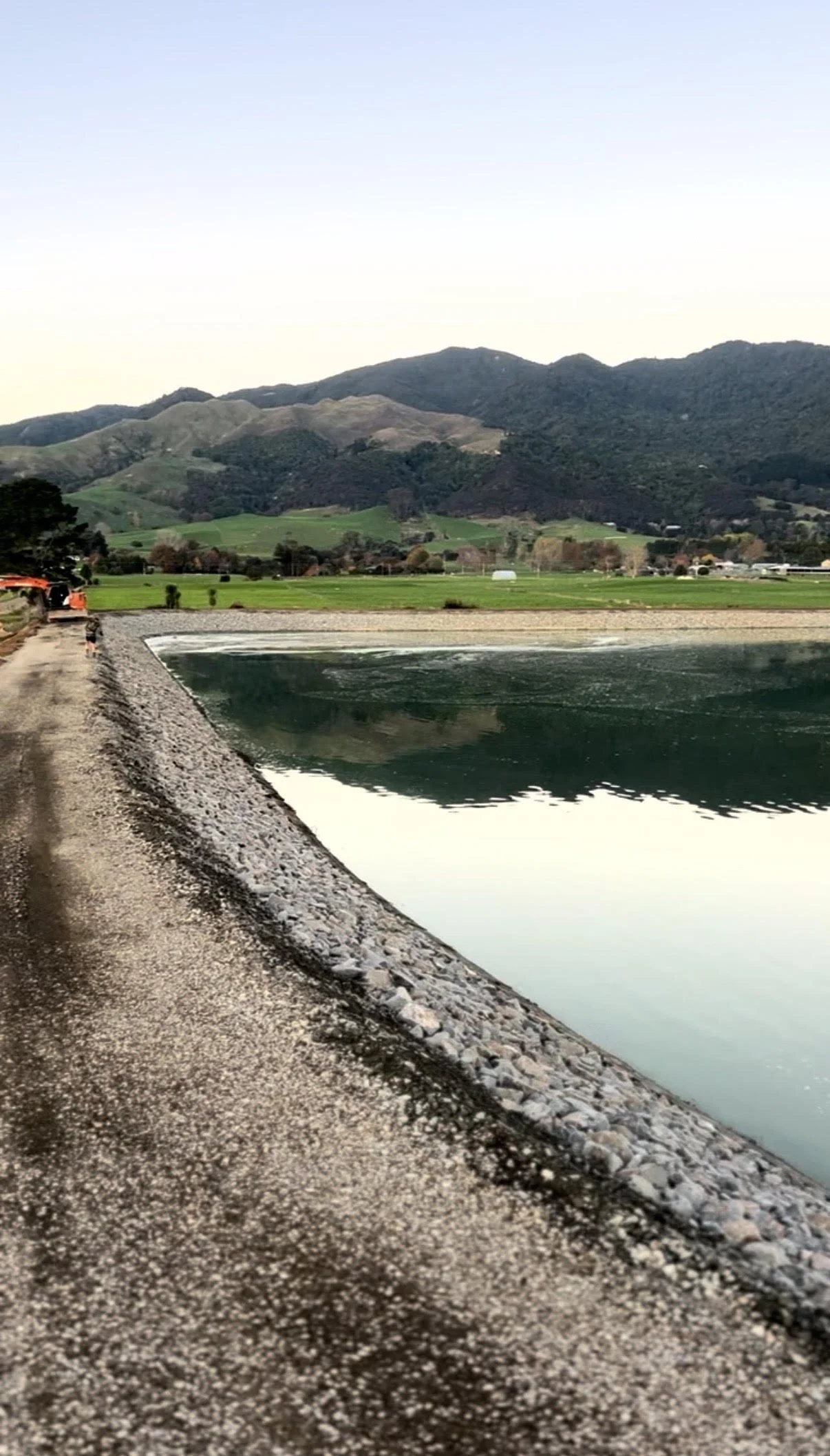 Large-scale earthmoving operation with piles of dirt and construction vehicles