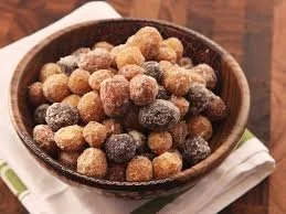 A bowl of dried fruits, likely a mix of dried cherries, apricots, and other fruit pieces.
