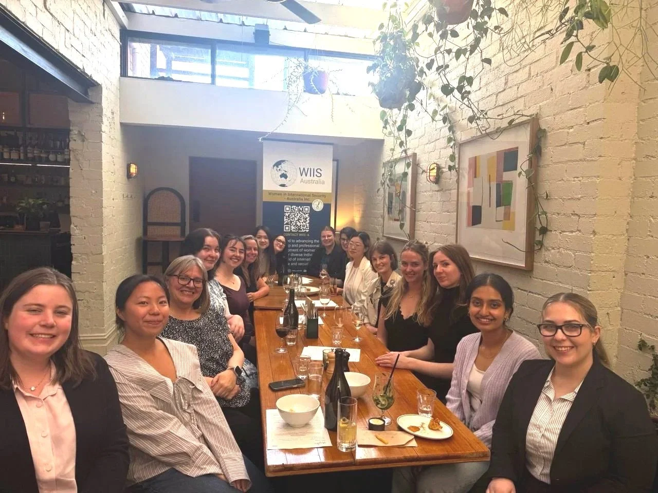 A group of women sitting together at a restaurant in Melbourne conversing.