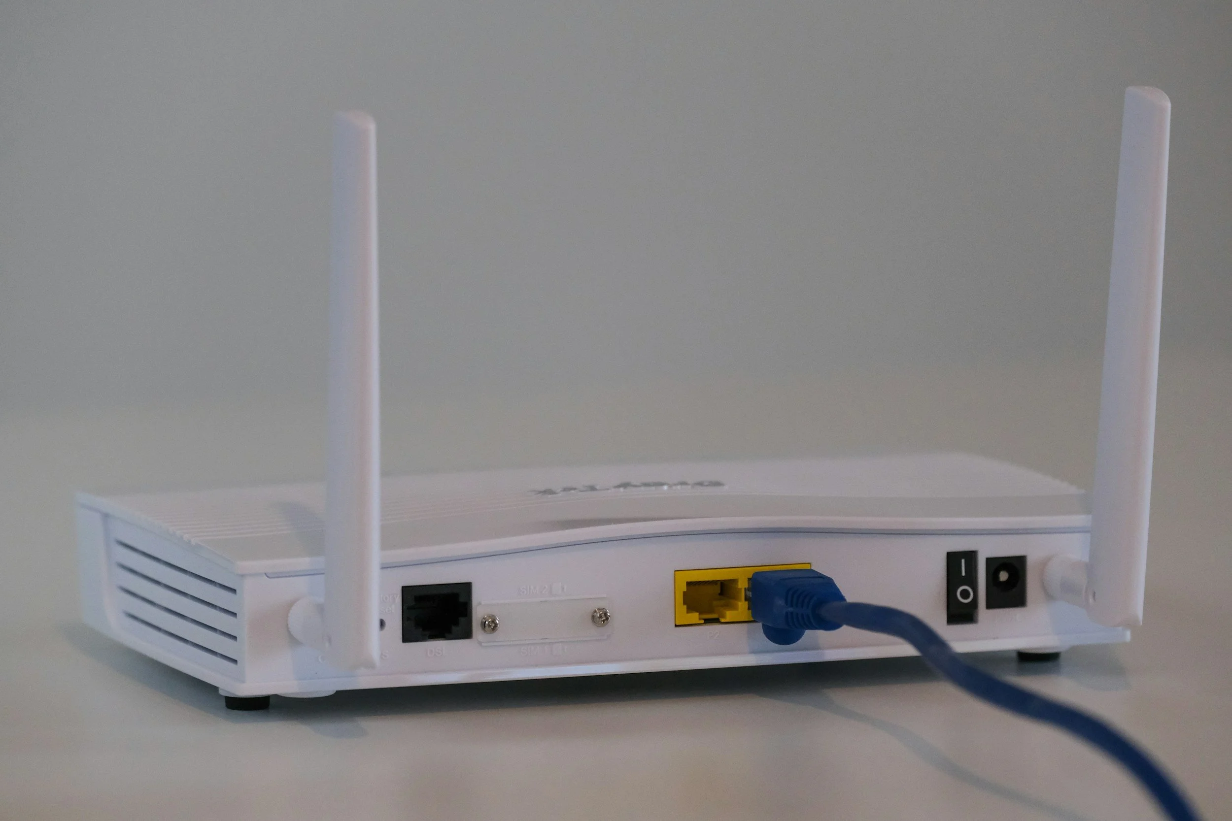 Wireless router with Ethernet cables connected to its rear ports