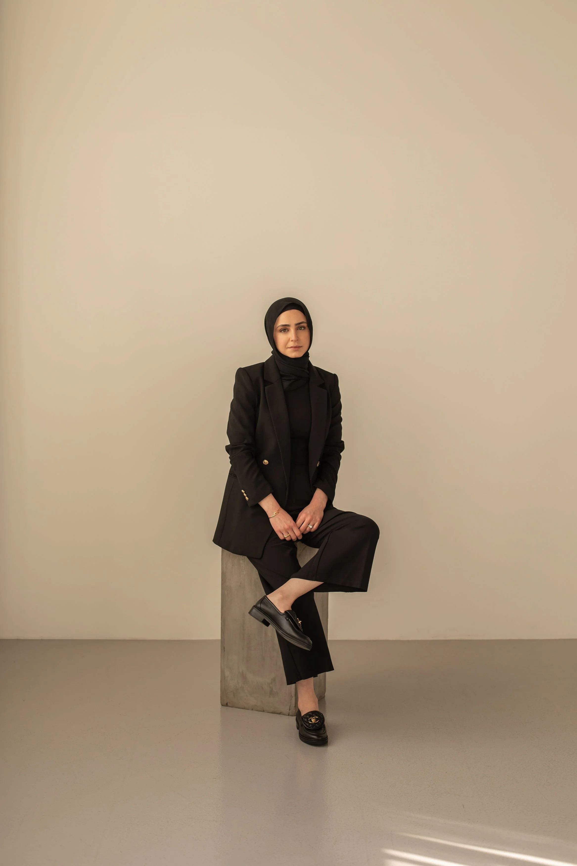 Rawan Kaddoura, Founder and Creative Director of Siya Studio, seated against a neutral studio backdrop