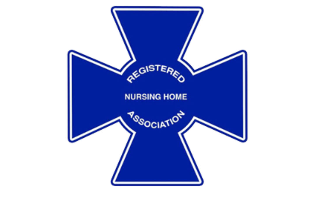 Blue insignia shaped like a Maltese cross with white outline, featuring the text 'REGISTERED NURSING HOME ASSOCIATION' inside, and 'REGISTERED' and 'ASSOCIATION' curved around the top and bottom of the cross.