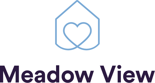 A logo with overlapping hearts inside a geometric shape and the words 'Meadow View' below it.