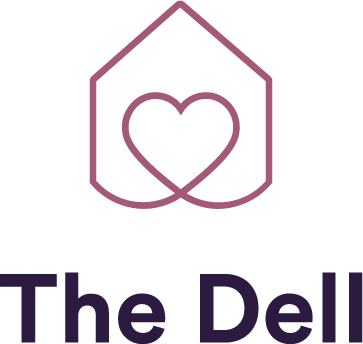 A logo with a heart inside a house outline above the text "The Del".