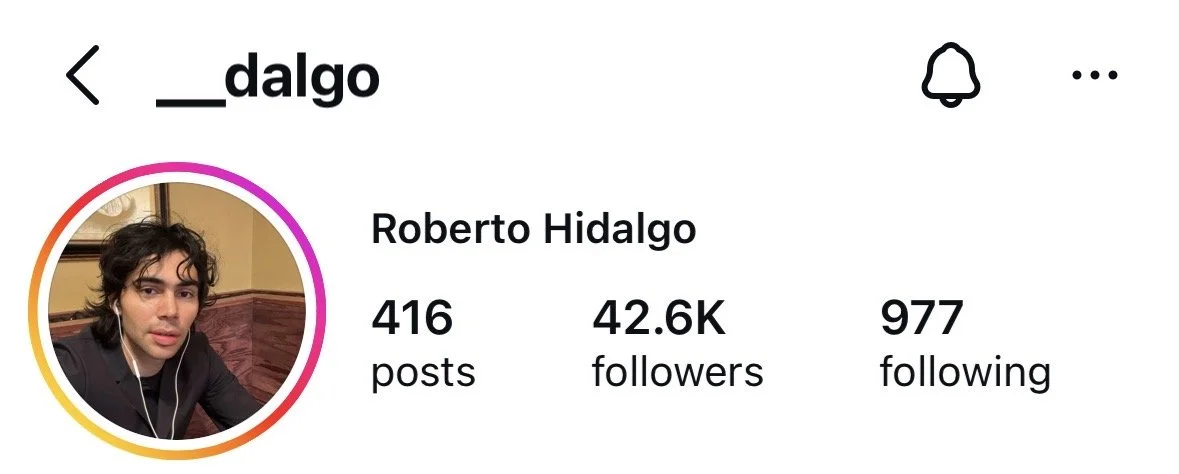 Instagram profile page showing a profile picture of a young man with dark curly hair, wearing earphones. The profile belongs to Roberto Hidalgo with 416 posts, 42.6K followers, and 977 following.