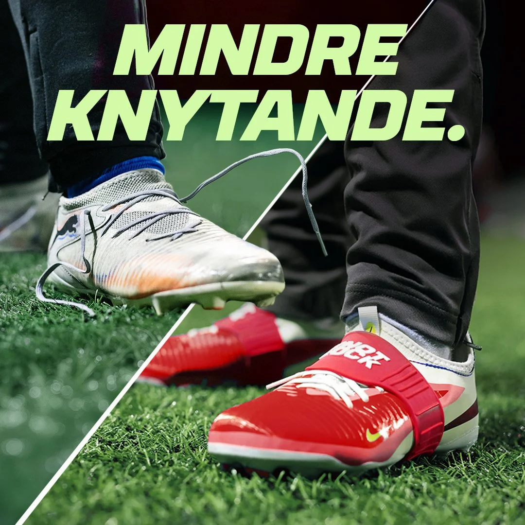 A close-up of a person tying the shoelaces of two different athletic shoes, one white and one red, on a grass field.