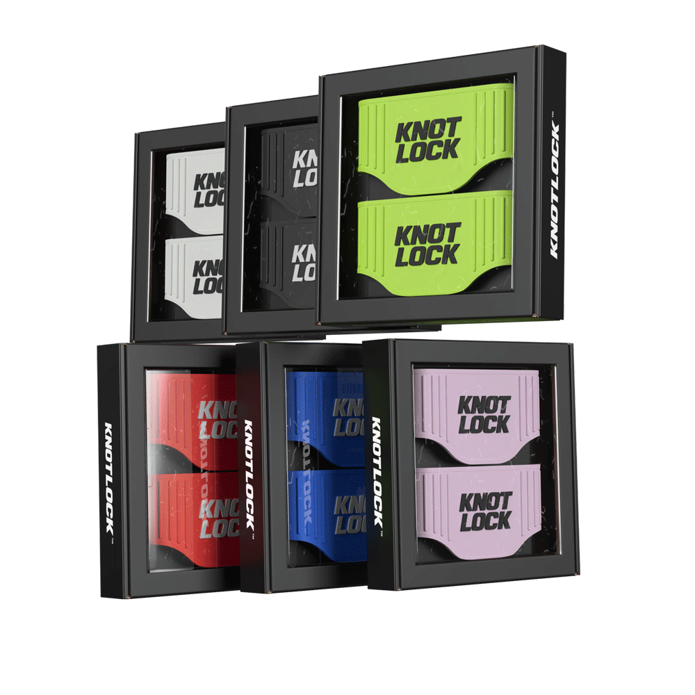 Boxes of Knot Lock wristbands in various colors: white, black, green, red, blue, and purple, arranged in a display case.