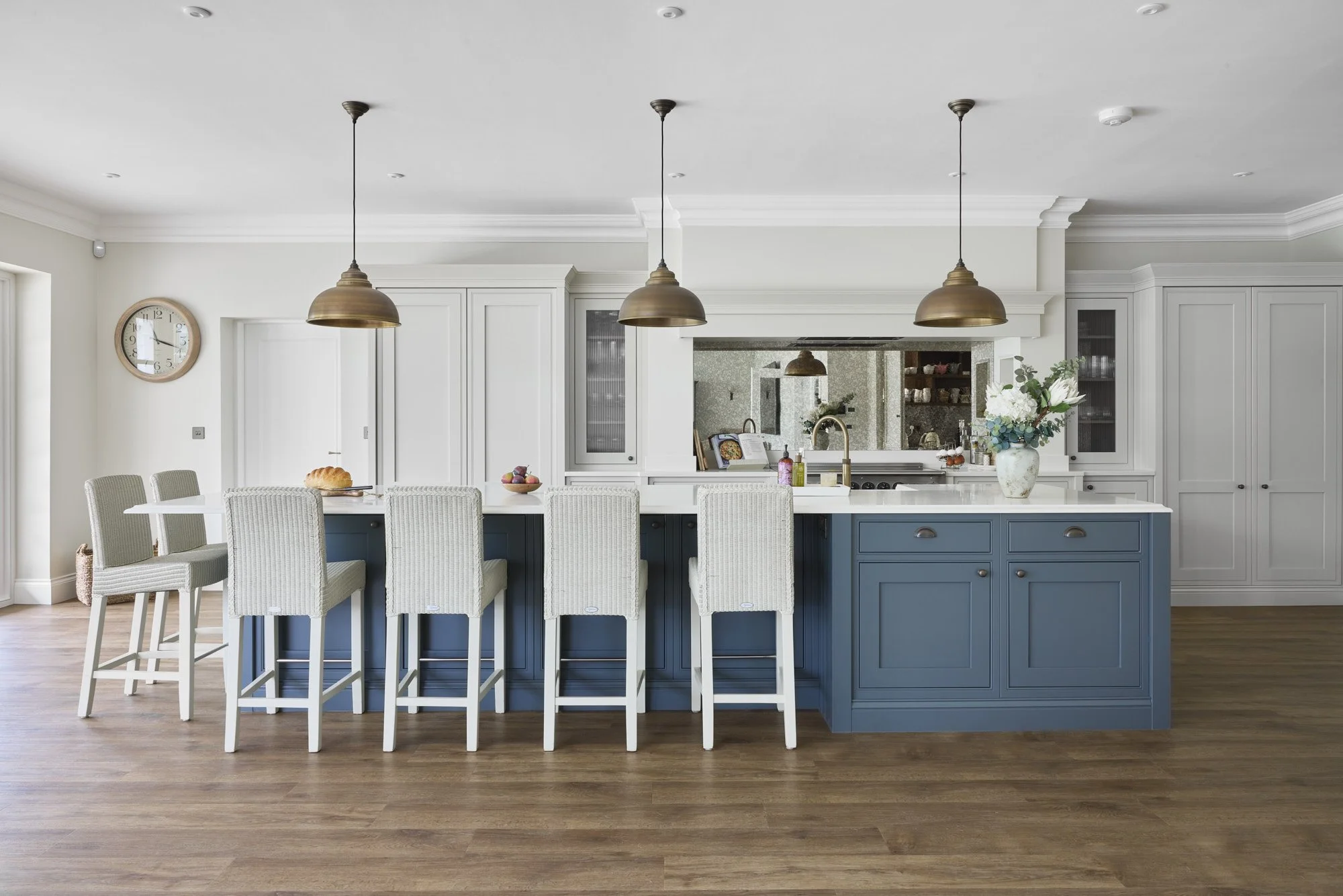 This beautifully crafted 1909 Ovolo kitchen is a timeless example of classic British kitchen design, blending traditional detailing with contemporary functionality. Featuring elegant painted in-frame cabinetry in a refined blue and soft neutral palet