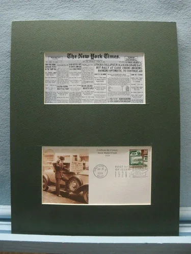 A framed display shows a newspaper clipping of The New York Times at the top and a vintage postal cover with a black-and-white photo of a man and a clock at the bottom.