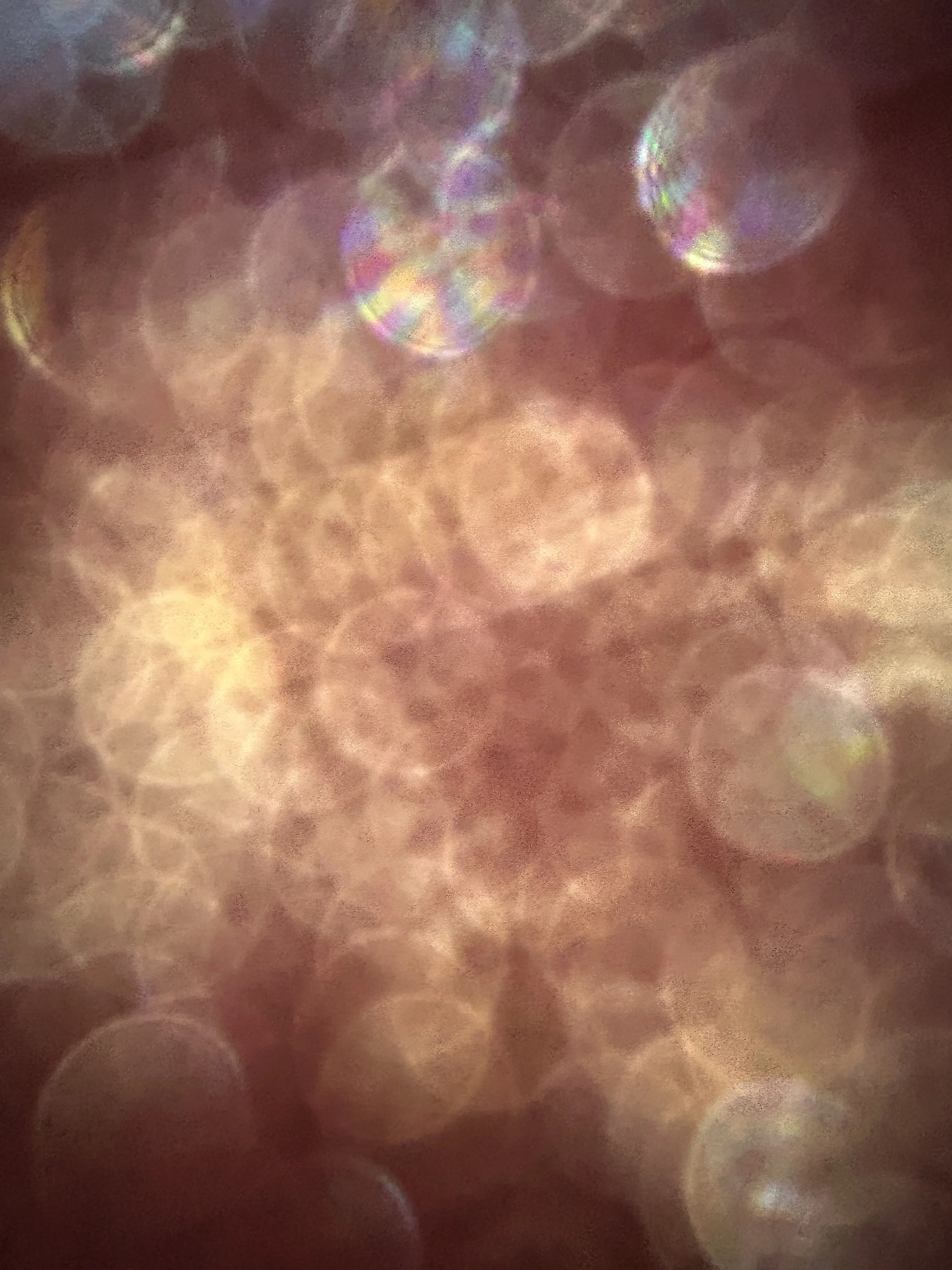 Blurry and colorful bokeh photo with overlapping circular light reflections.