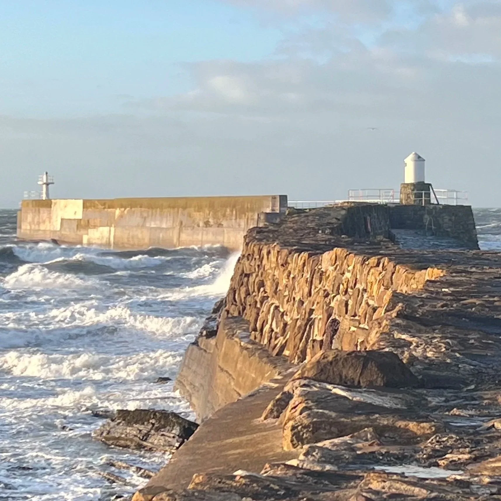 A lighthouse in the waves representing the power of Wellbeing Coaching