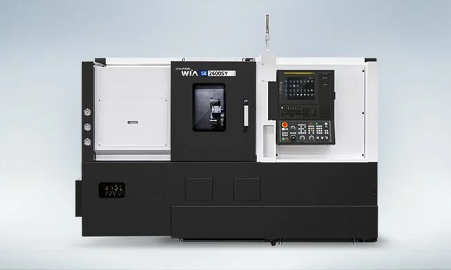 A CNC metalworking machine with controls and a viewing window.