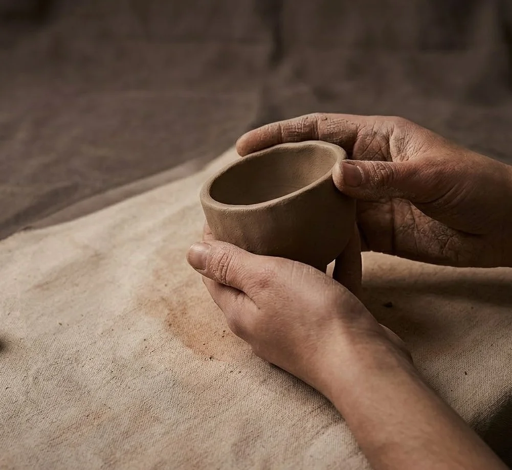 hands holding clay workshop