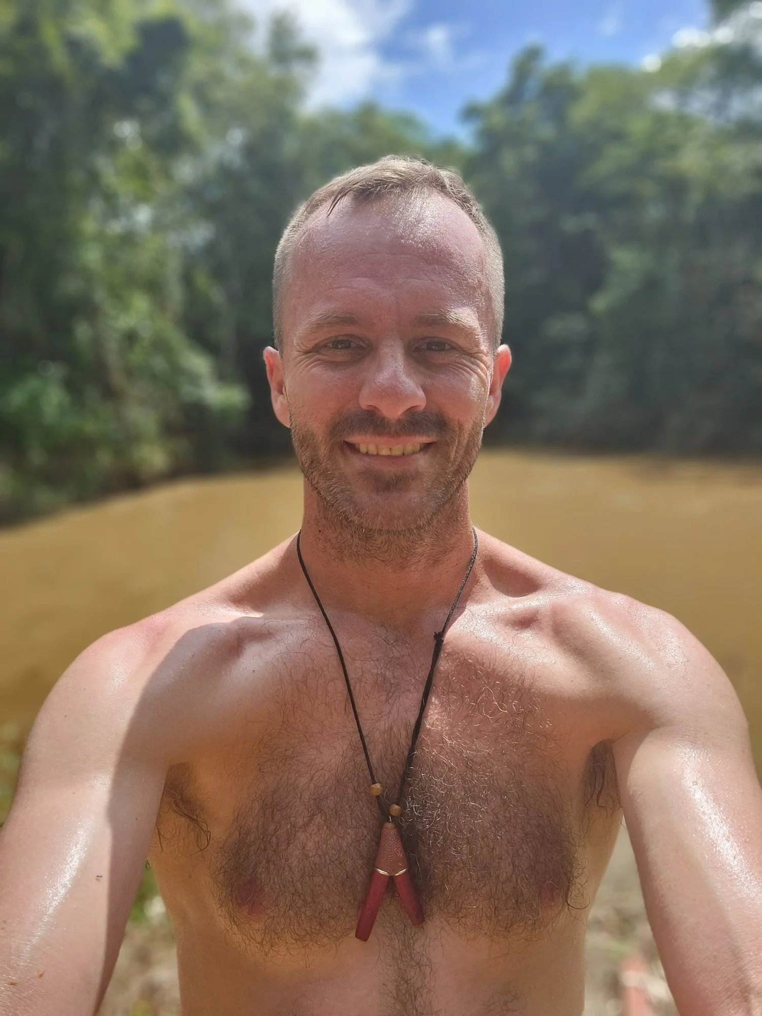 Chris Haynes, founder of Rebirth Healing Center, smiling outdoors in the Amazon near Iquitos