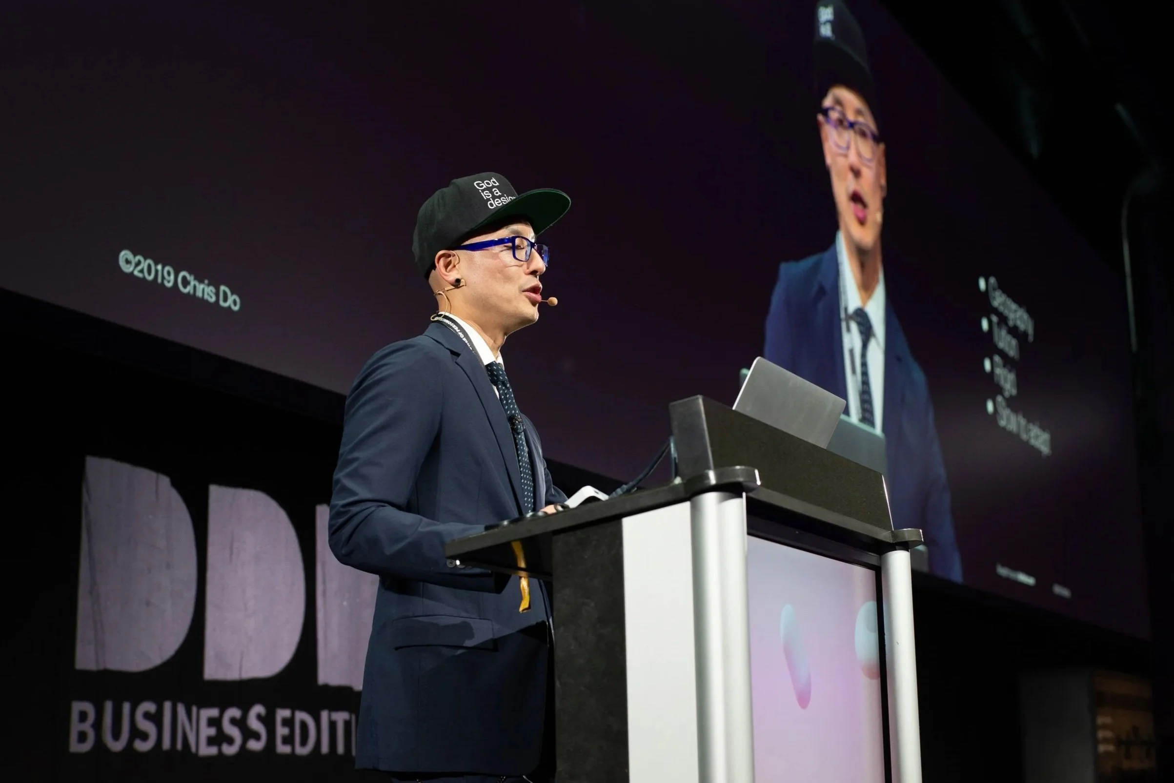 Chris Do delivering a keynote presentation on stage at Digital Design Days