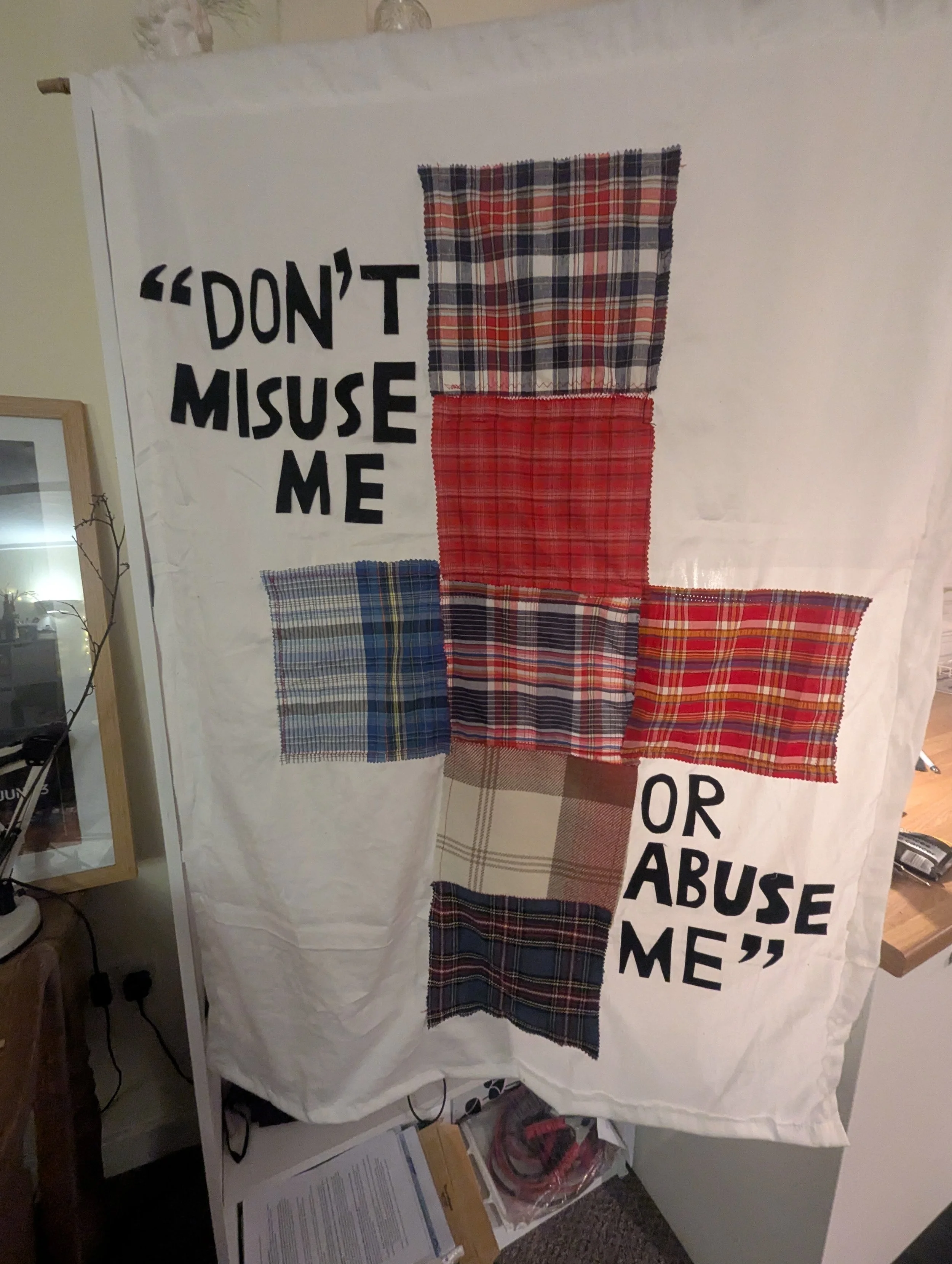 A quilt chart made of six fabric swatches with the quote "Don't misuse me or abuse me" in black letters.