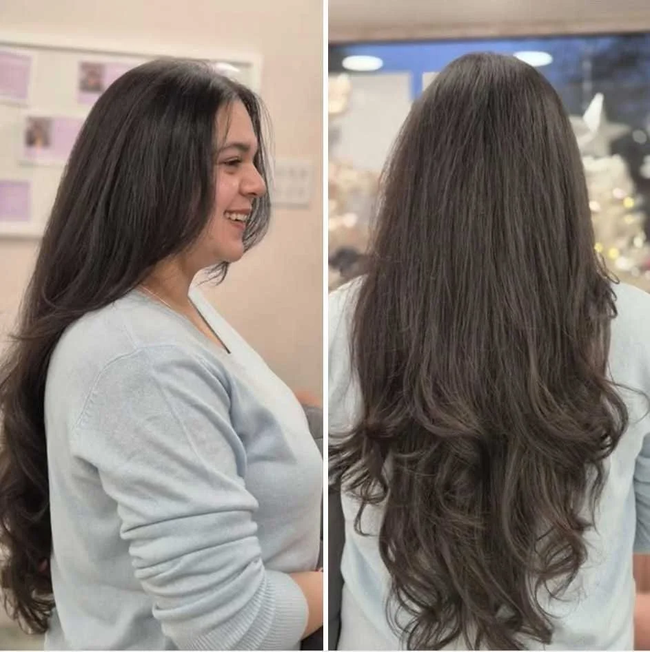 Side and back views of a woman with long, wavy brown hair in an indoor setting.