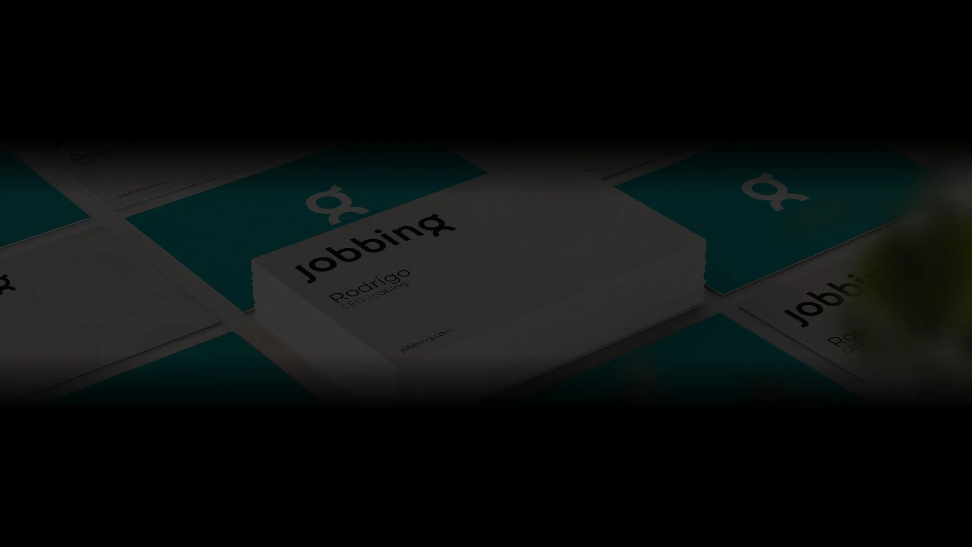 Stack of Jobbing business cards with green and white design.