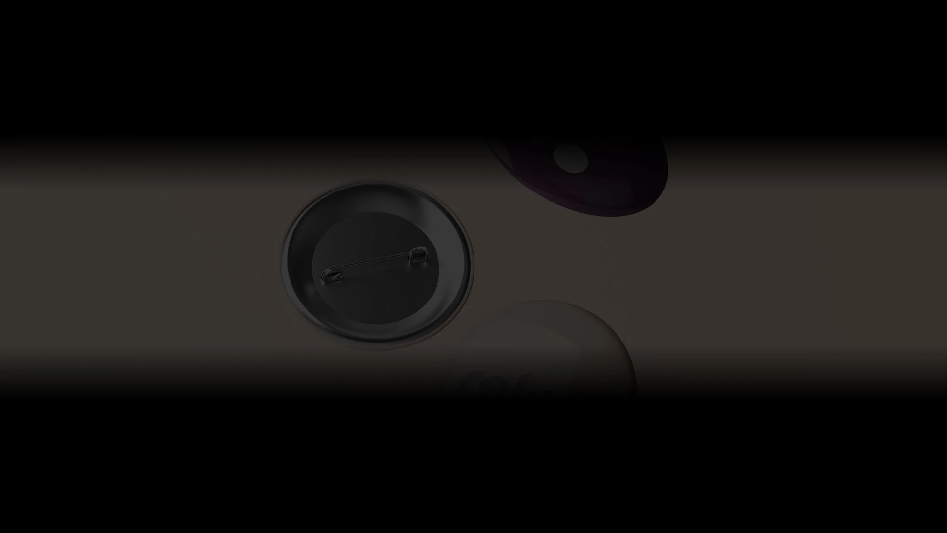 Back view of multiple round button badges with pins partially visible in low light.