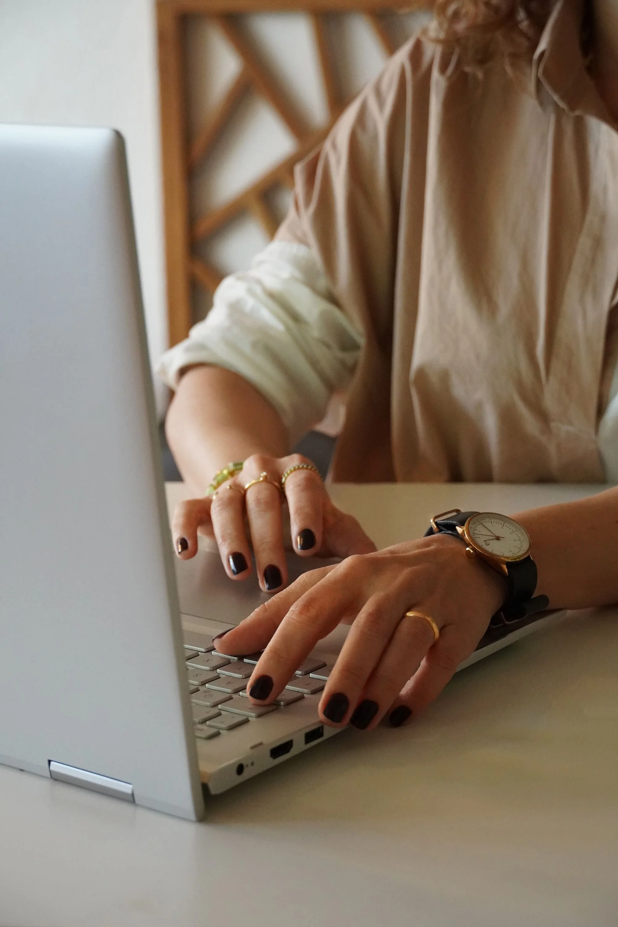 Freelance Sales Manager typing on a laptop during a client consultation