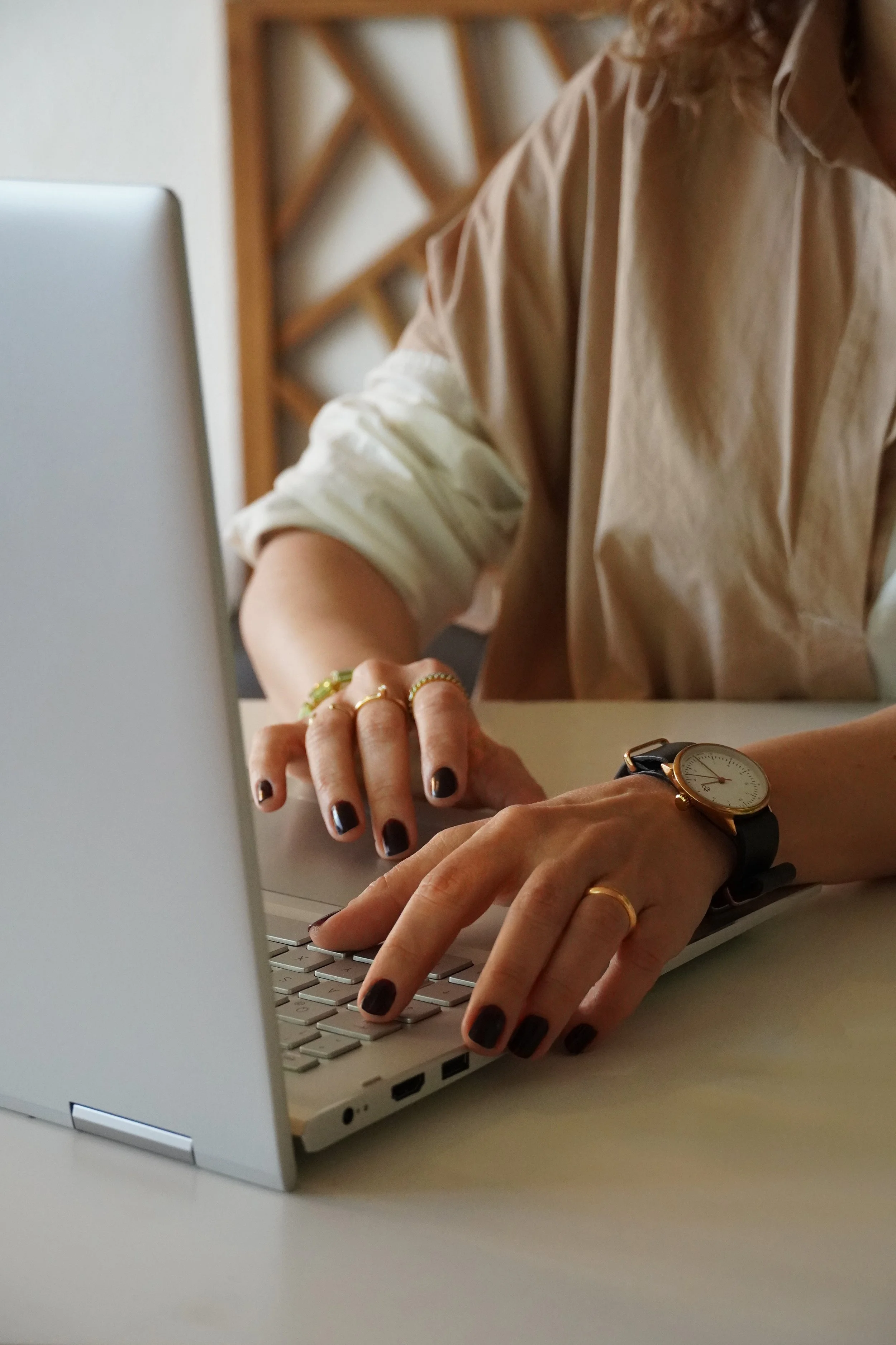 Sales & Business Development consultant working on laptop, designing sales processes and go-to-market strategies for B2B companies