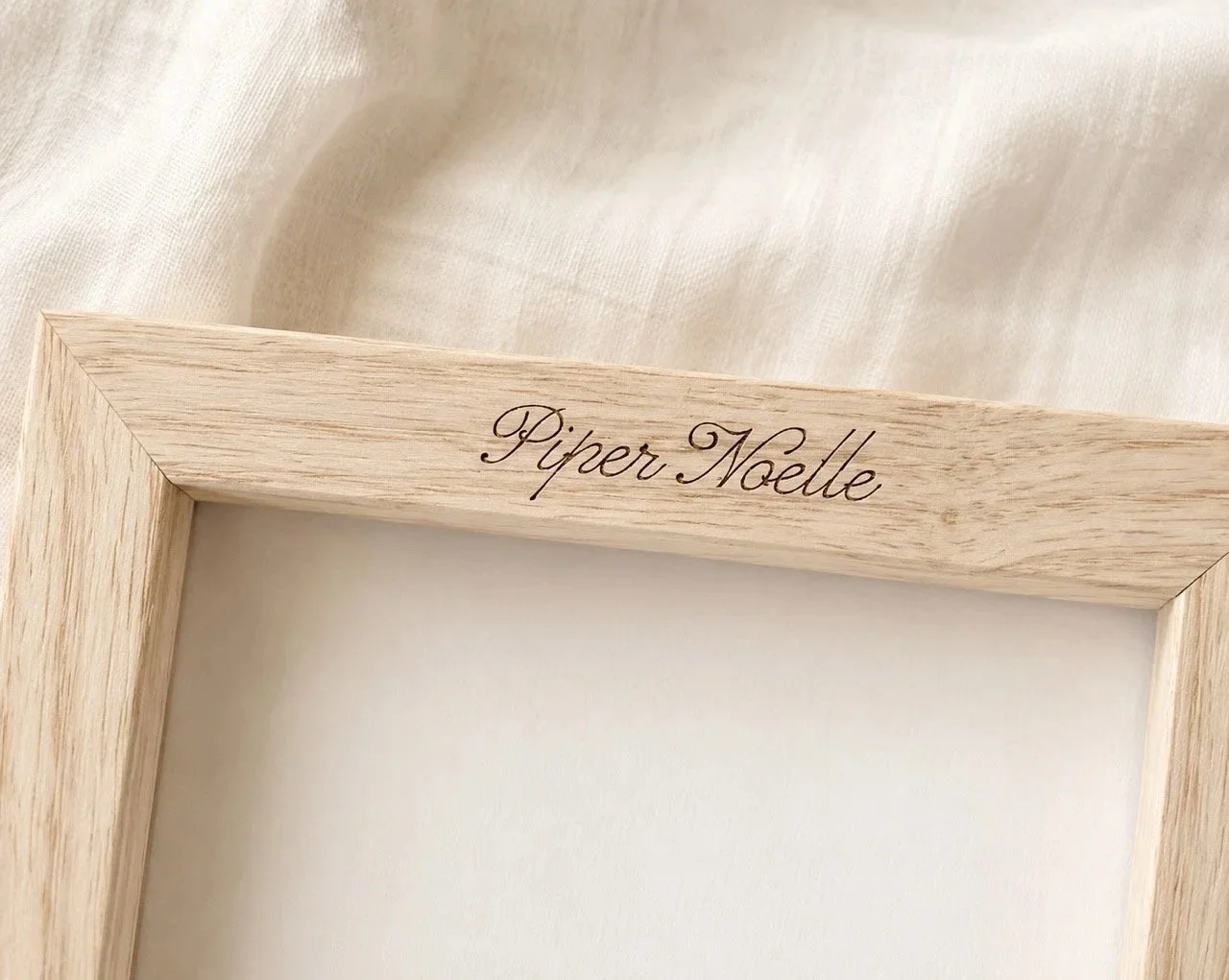 Close-up detail of a child’s name engraved on a personalized wooden Tooth Fairy keepsake box.