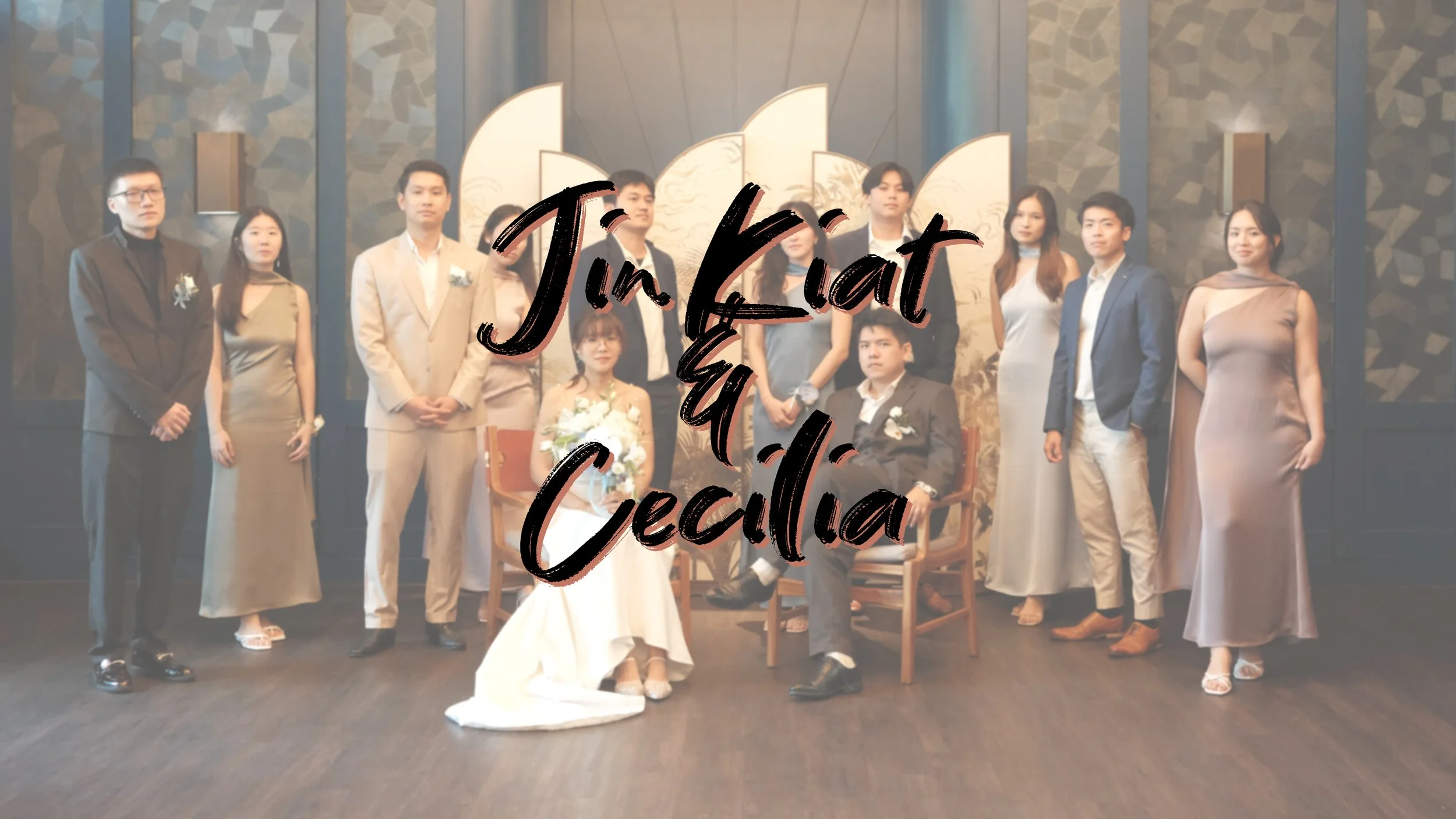 A group of people at a wedding celebration, with a bride and groom seated in the center, surrounded by friends and family. Overlaid text reads 'Jin Kat & Cecila'.
