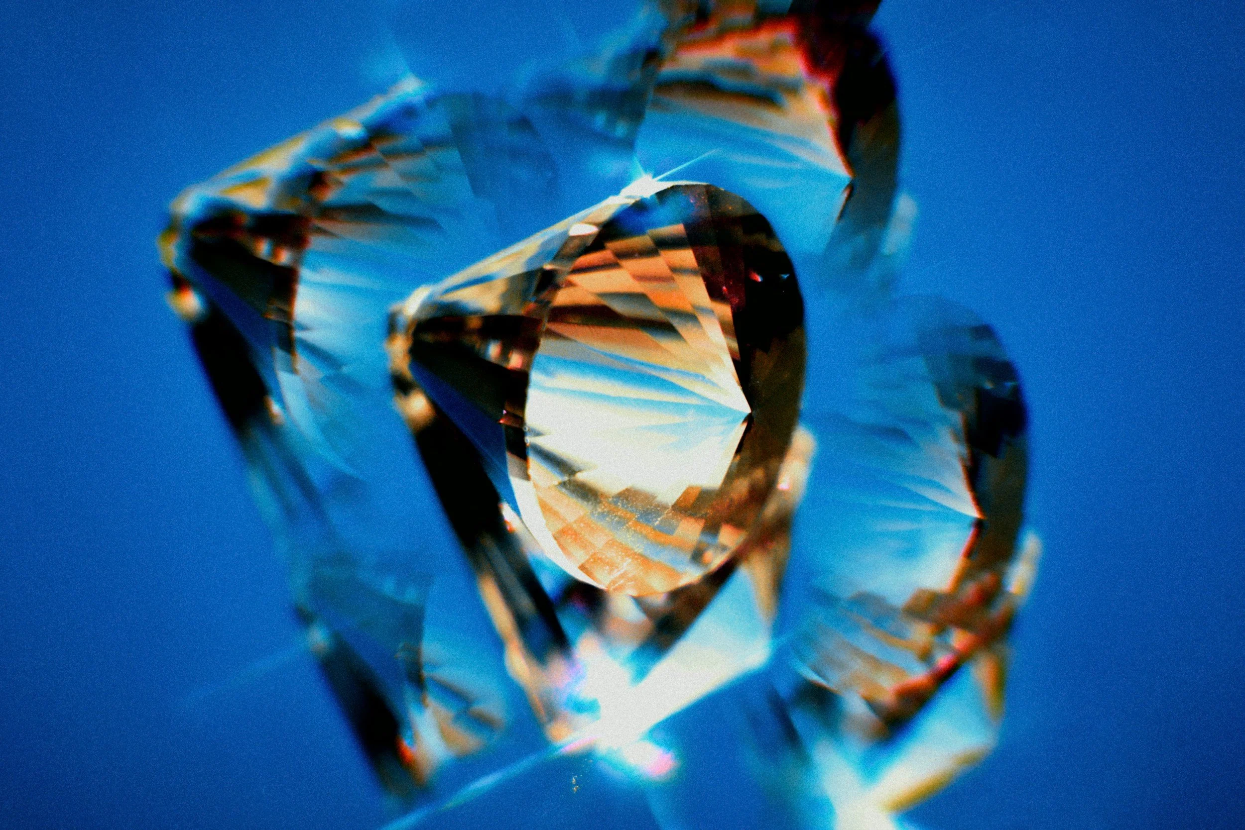 Close-up of a sparkling diamond against a blue background.