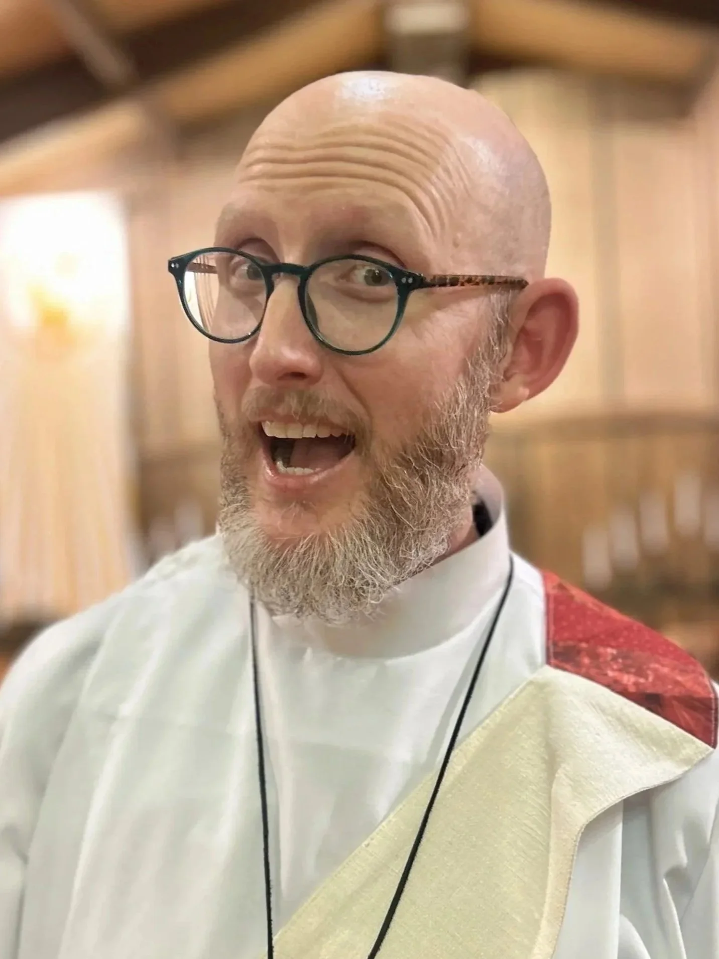 Rev. Dann Wigner smiling in the church.