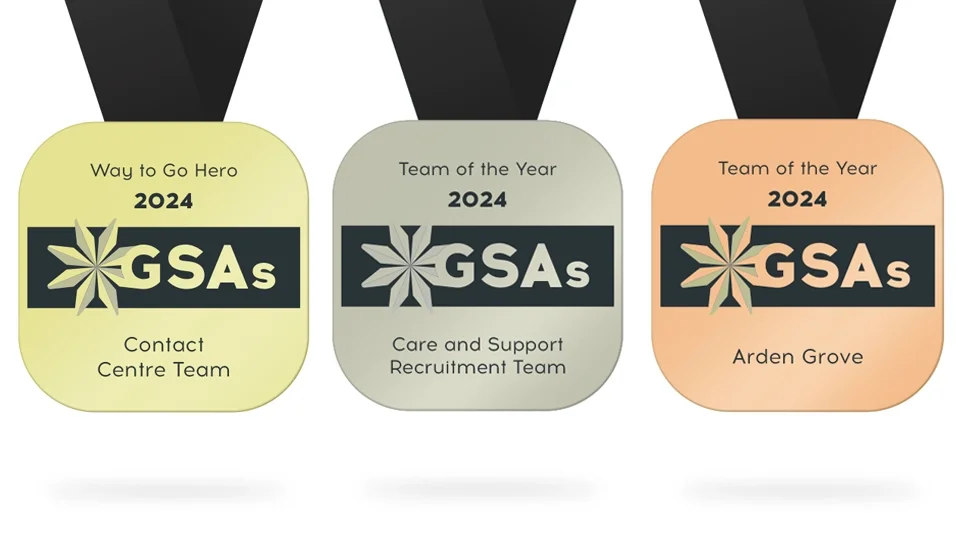 A flat lay design of three custom commemorative medals in gold, silver, and bronze. The design features a bold black horizontal band with the "GSAs" logo and the year 2024, demonstrating consistent brand application across physical event collateral.