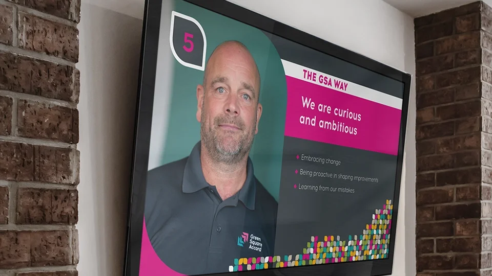 Digital display design using dynamic organic shapes, bold typography, and high-contrast color blocks to enhance readability in office spaces.