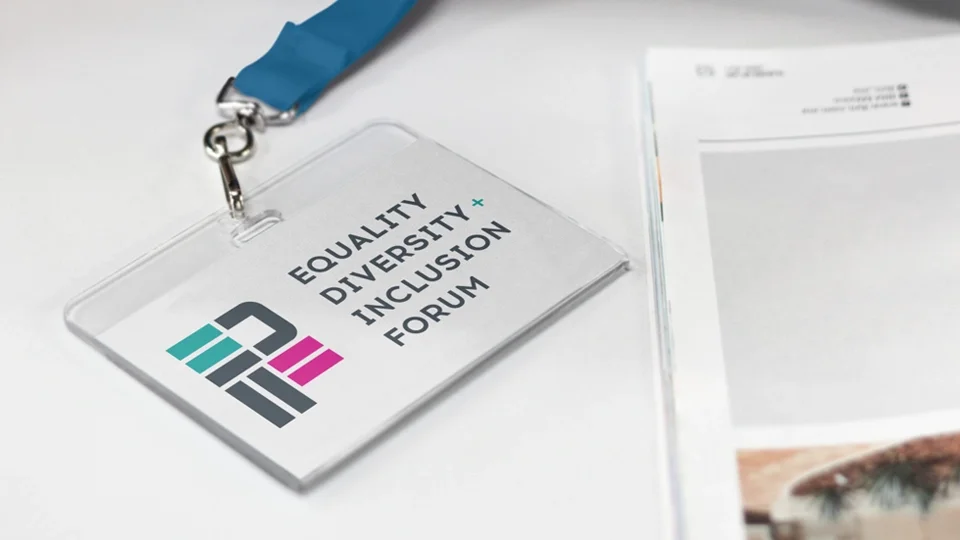 Modern geometric logo using teal and magenta bars on a professional ID badge lanyard for the Equality Diversity and Inclusion Forum.
