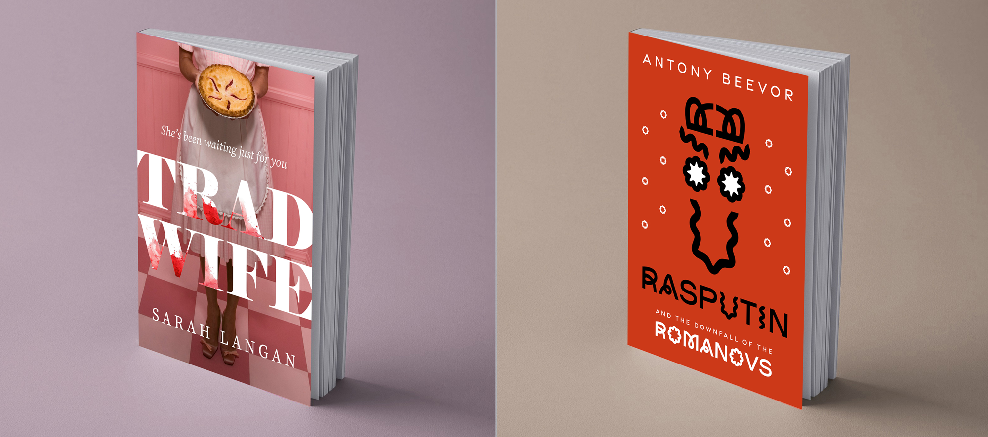 Two books standing upright on a surface. The book on the left, titled "Tradi Wife" by Sarah Langan, has a pink background with an image of a woman holding a pie or cake and wearing a pink apron. The title is in large white and red letters. The book on the right, titled "Rasputin and the Downfall of the Romanovs" by Antony Beevor, has a red background with a black abstract line drawing and text in white and black.