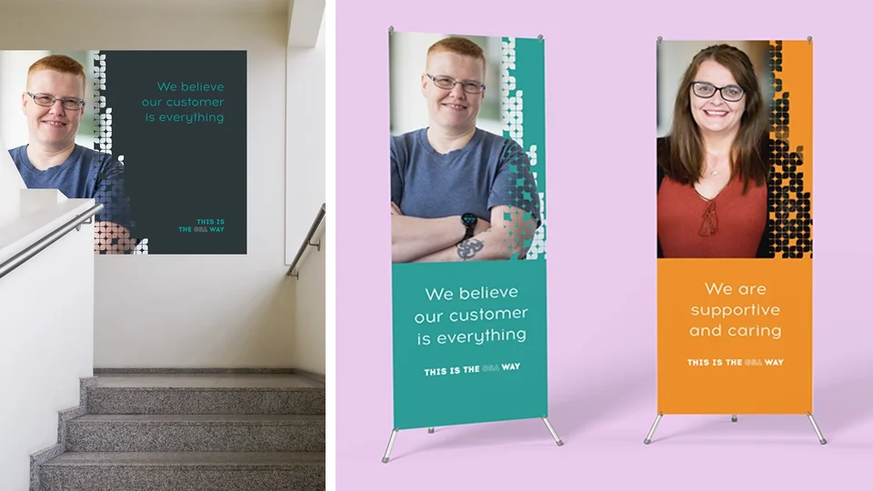 Large-format environmental graphics showcasing consistent brand application across textured wall vinyls and sleek exhibition banners.