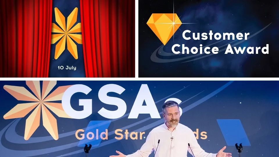 A man giving a speech at an award event with GSA branding, standing in front of a blue backdrop with the GSA logo, and two screens displaying the words 'Customer Choice Award' and a diamond icon, with a date of July 10.
