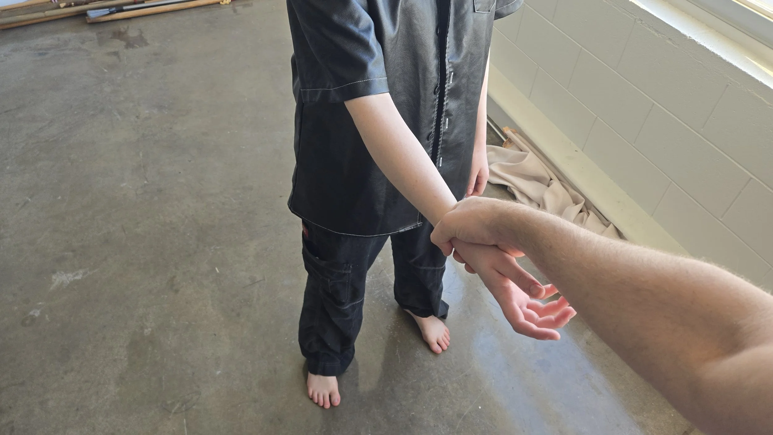 A man's hand is reaching over and grabbing my wrist.