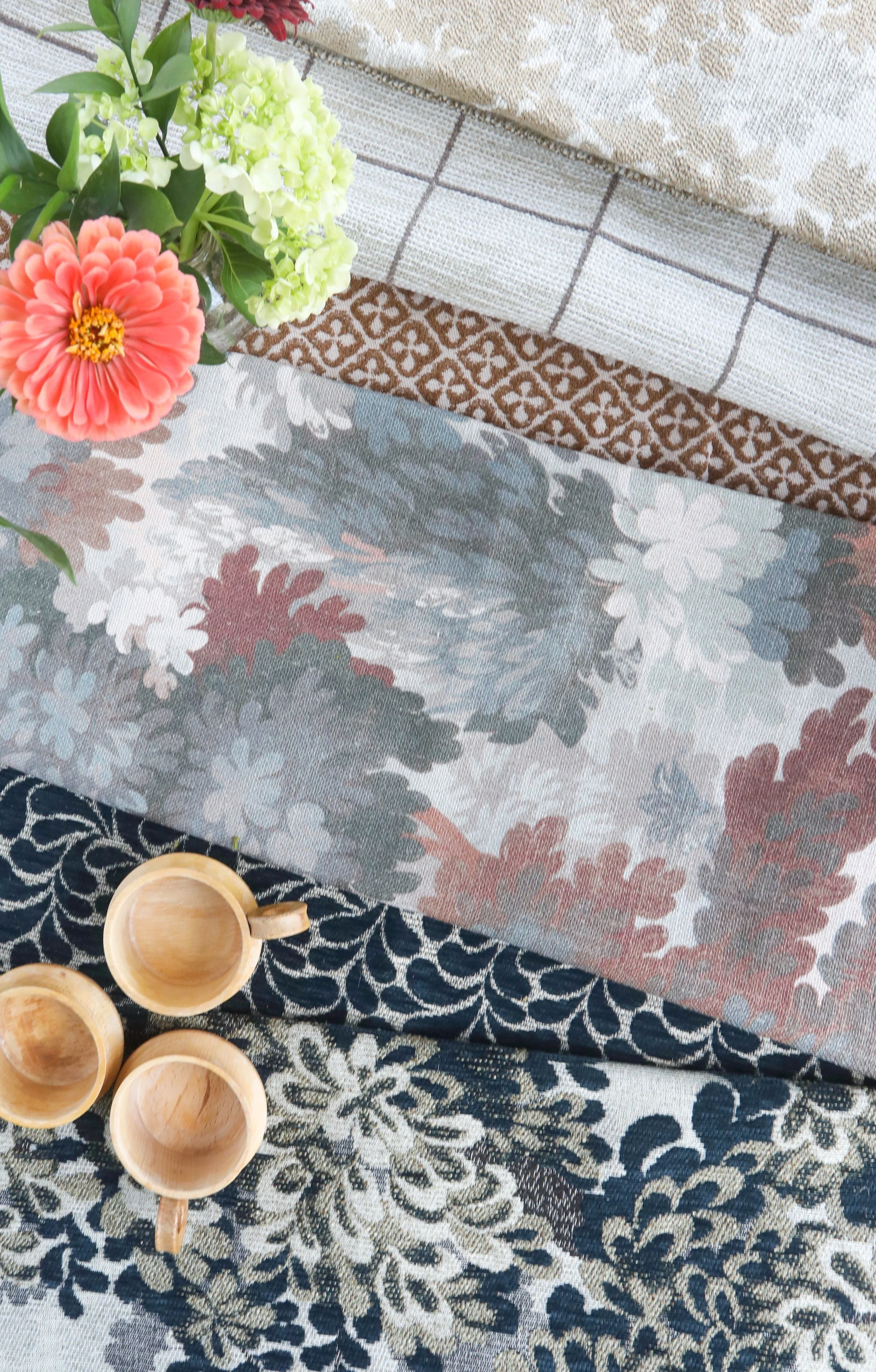 Curated fabric and textile selections styled to showcase pattern, texture, and color in residential interior design.