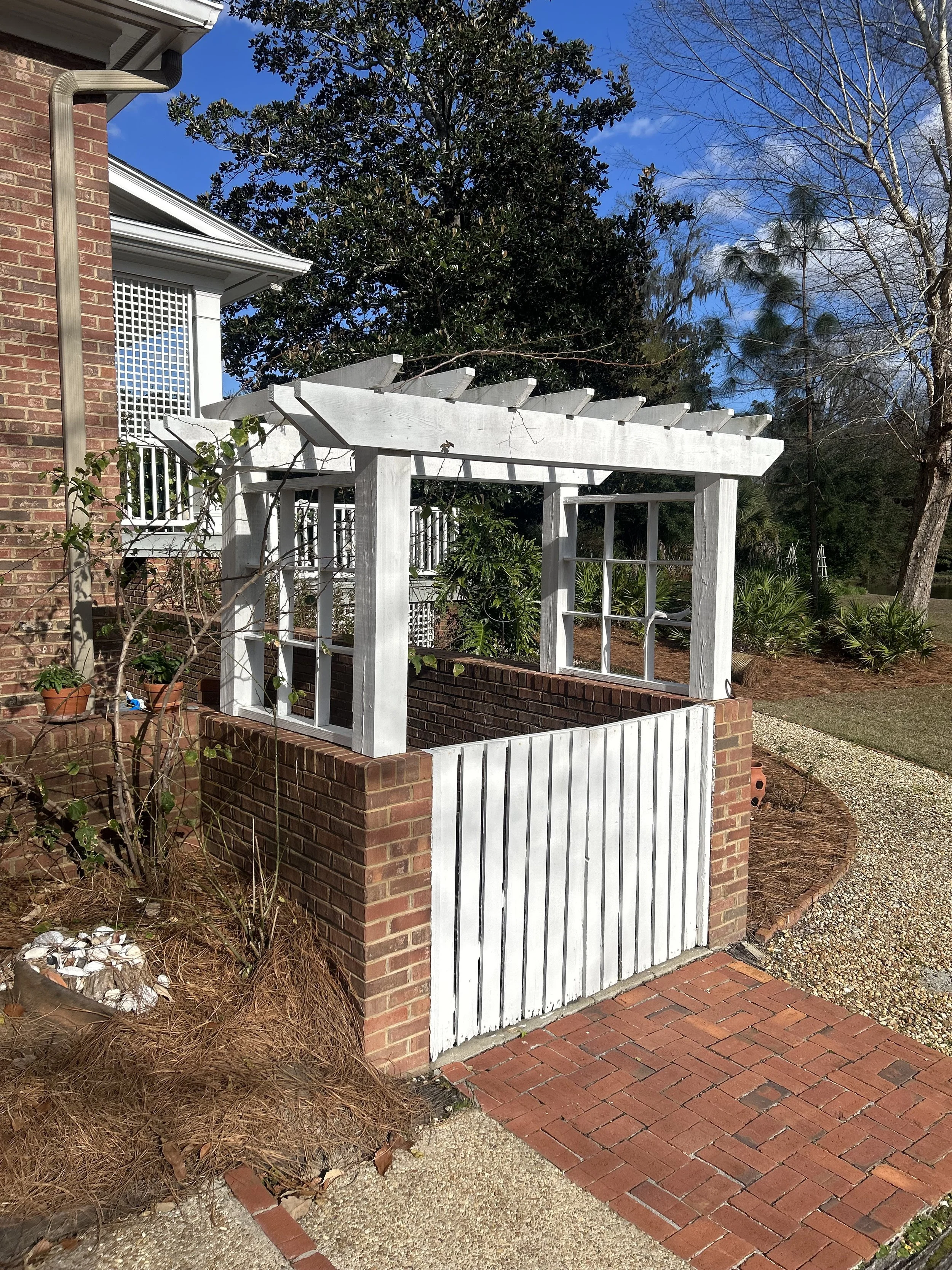 Custom wooden garden arbor and gate installed by South Oak Landscape in Thomasville, GA, featuring professional hardscaping and entryway design