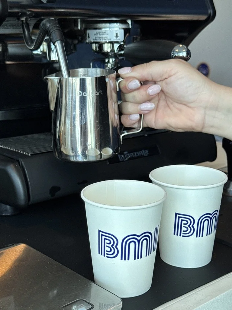Barista steaming milk for espresso drinks at a corporate coffee catering event in Miami