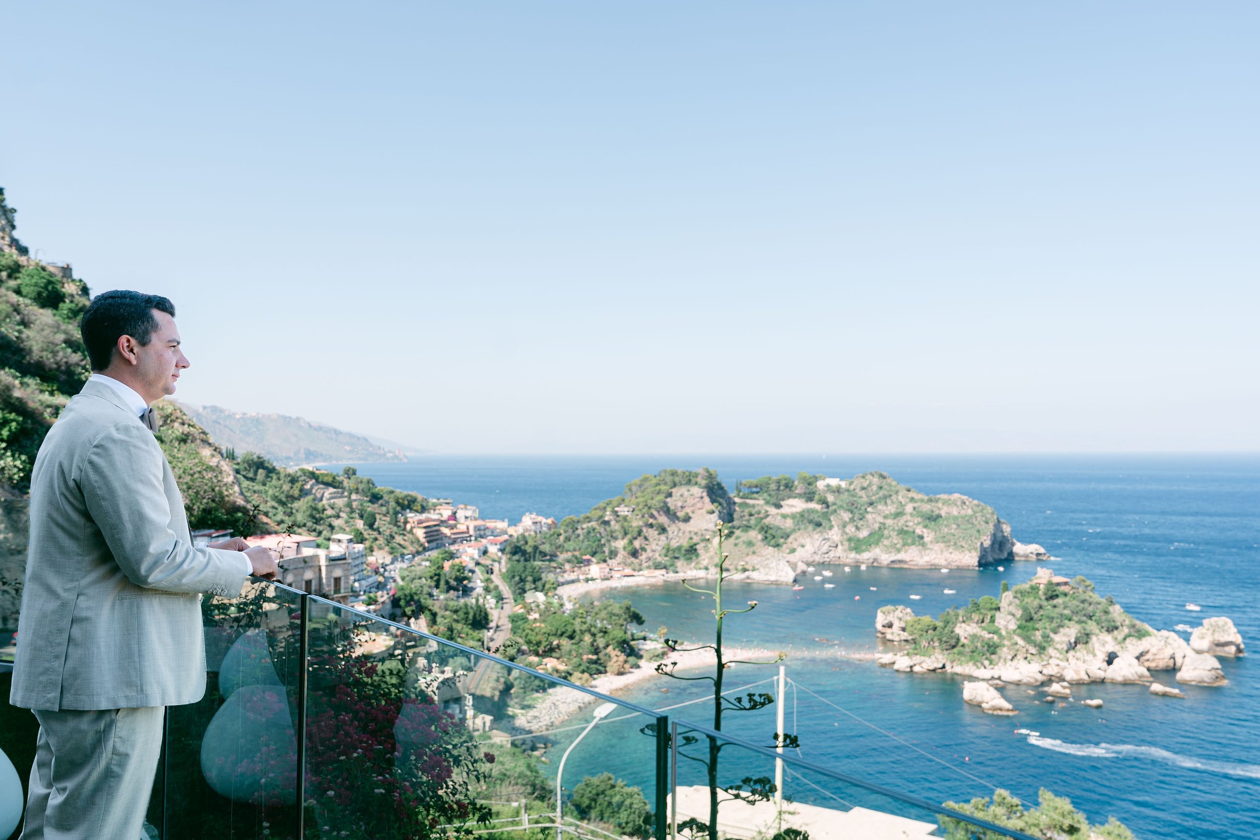 Groom Ryan keeping the nerves down while looking at the breathtaking view of Isola Bella, Taormina, Sicily. 