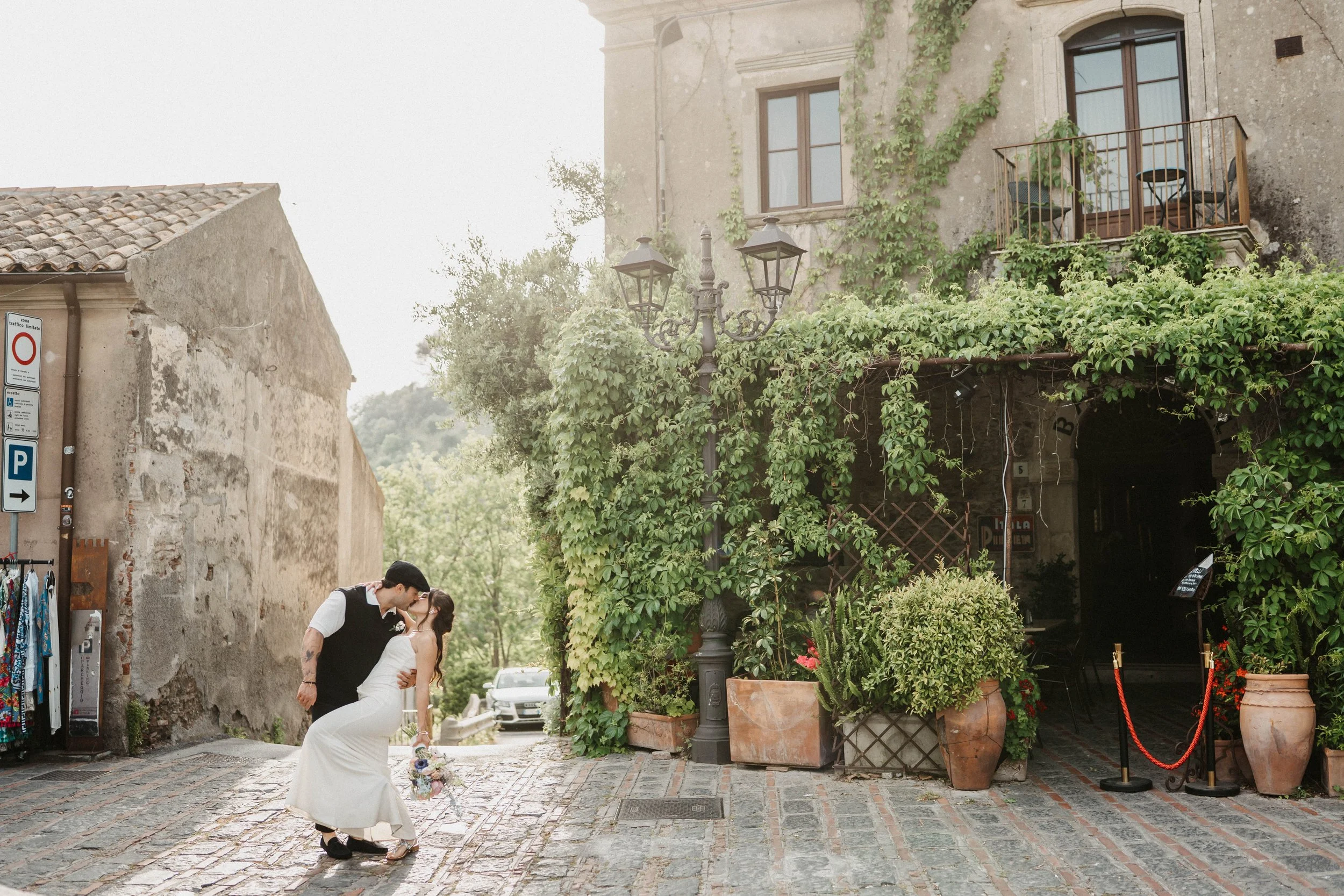 The bride & groom in front of Bar Vitelli, the famous bar where Michael Corleone asked for Appolonia's hand in the iconic Godfather film. 