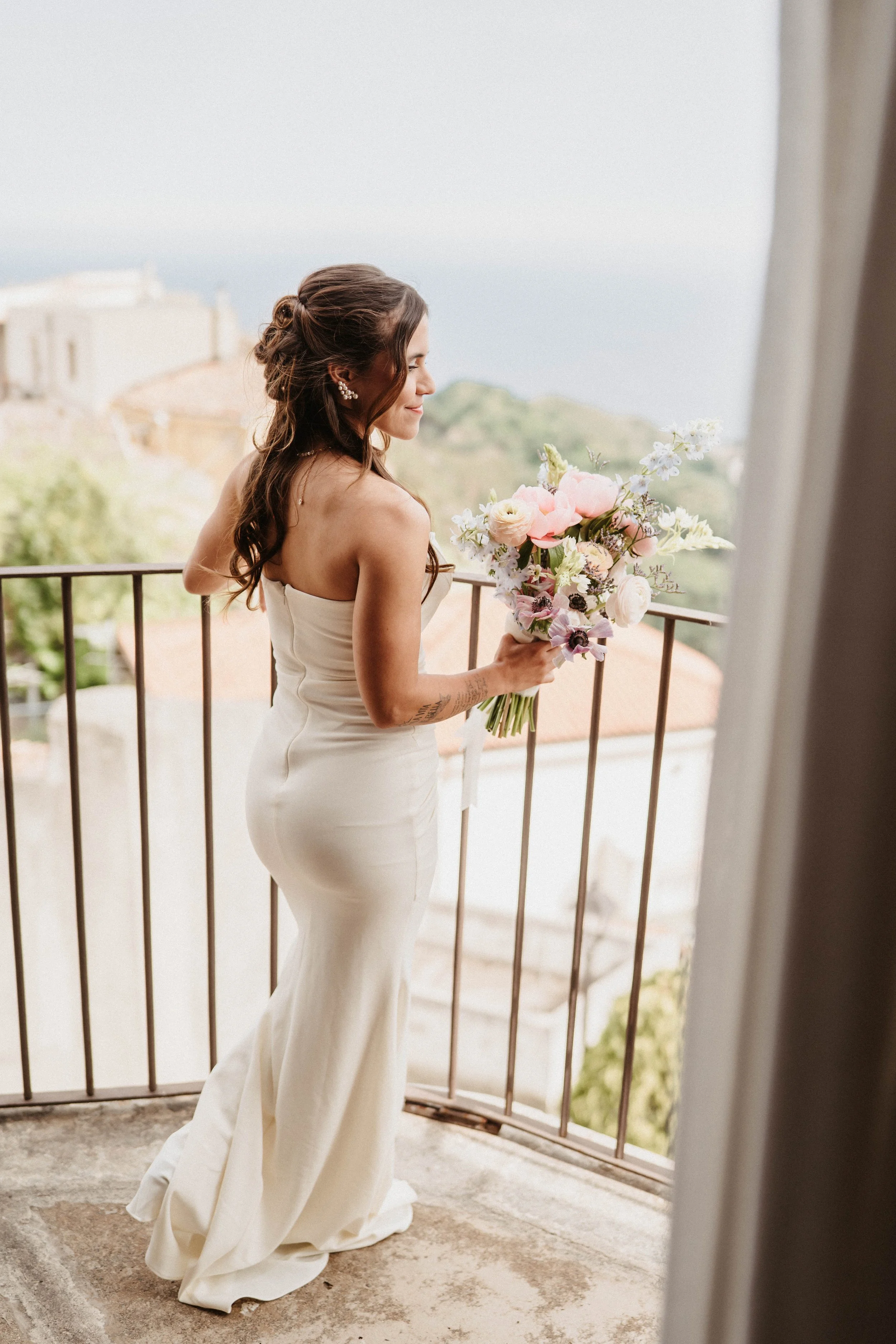 Bride Isabela enjoying the sea view from the bridal suite. 