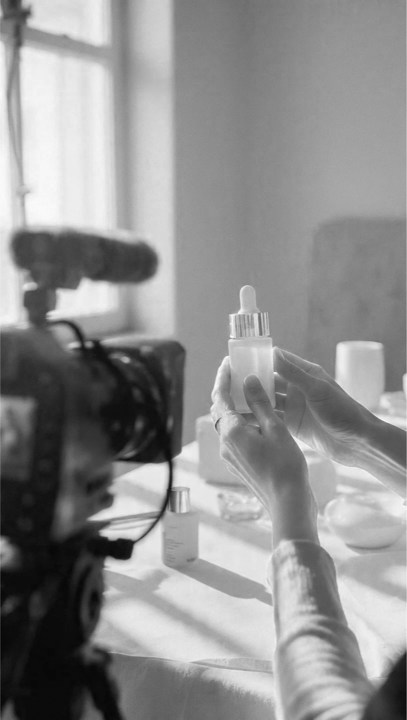 Person holding a dropper bottle in a well-lit room.