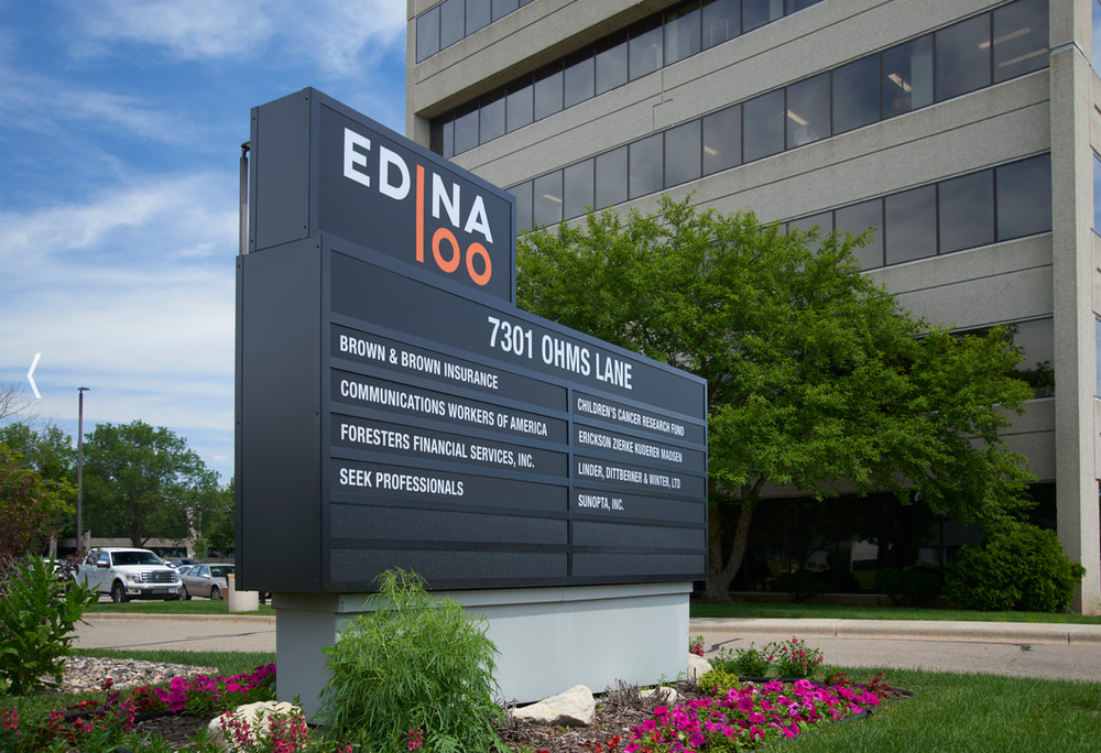 Edina 100 office building and entrance sign at 7301 Ohms Lane in Edina, Minnesota