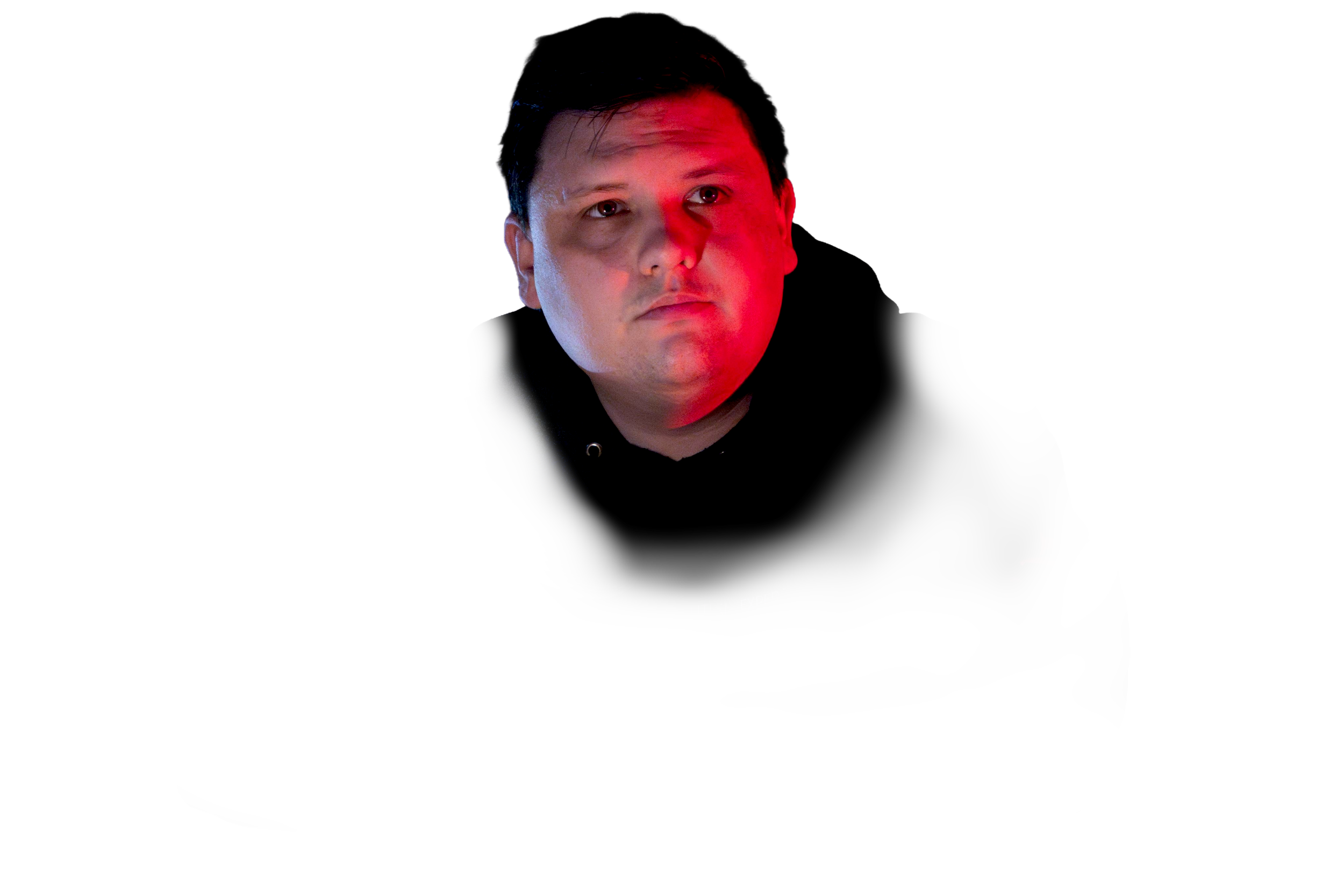 A man with a serious expression illuminated by red and blue lighting, wearing a black hoodie with partial text visible on the chest.