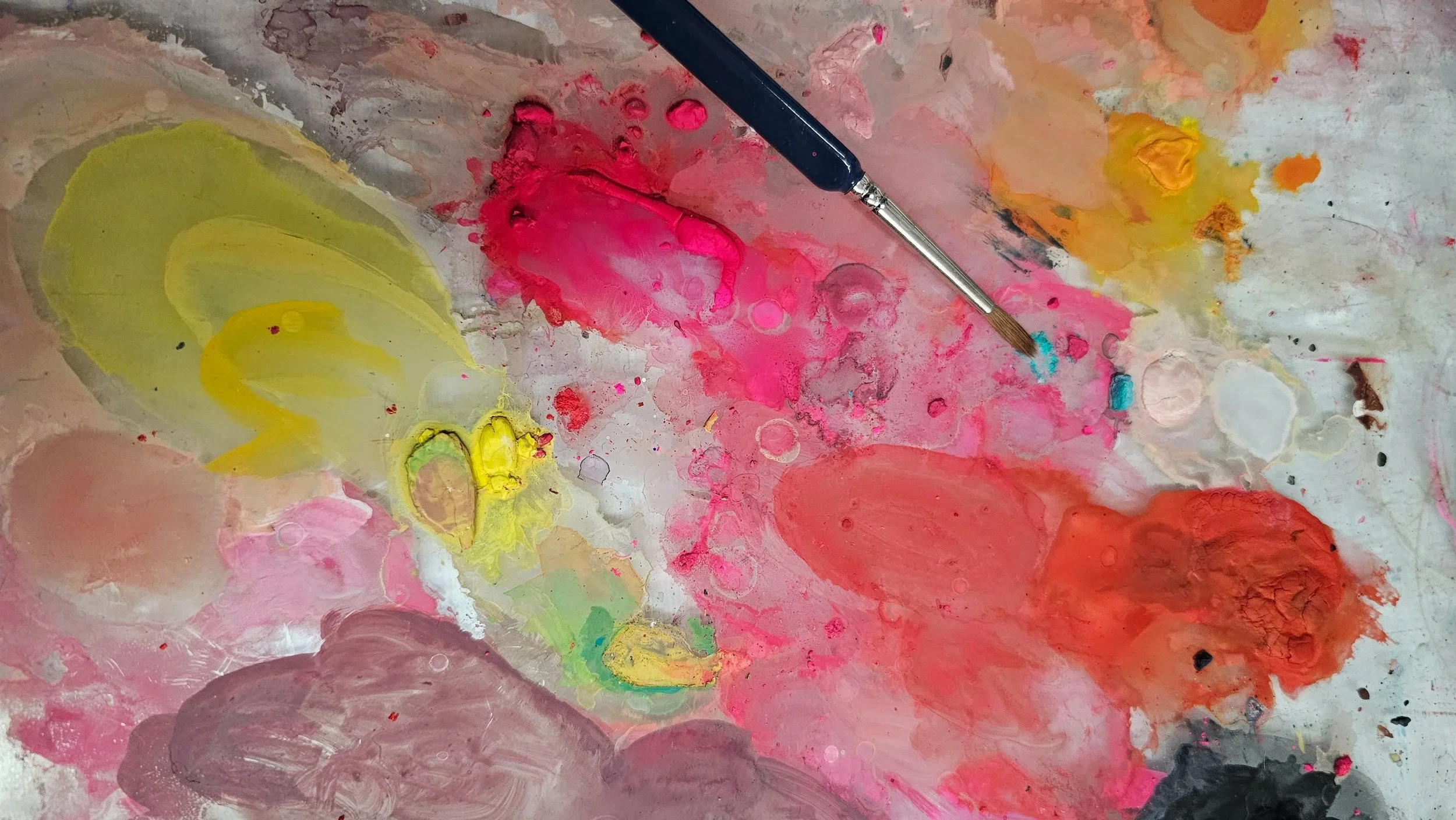 close-up of a paint palette showing dried watercolor paint