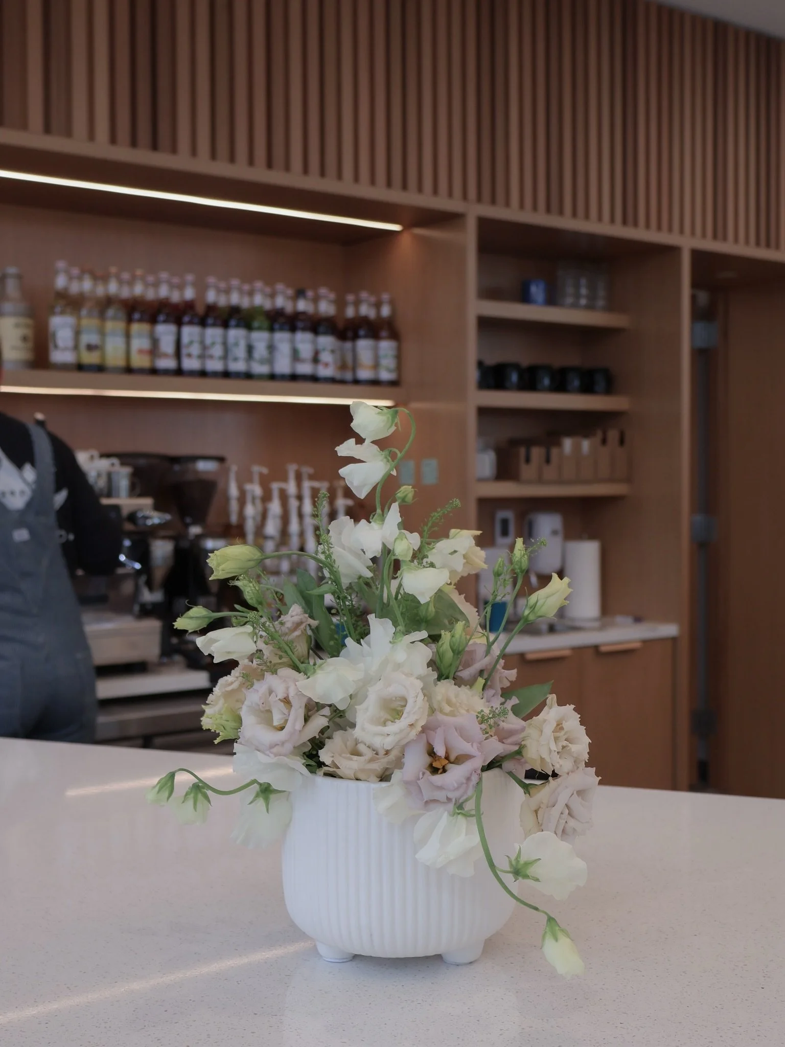 Some spaces deserve more than decoration; they deserve atmosphere.

This arrangement was designed for Zen Coffee Co. with that in mind: something soft, intentional, and quietly welcoming.

The goal is never to simply place flowers on a counter, but t