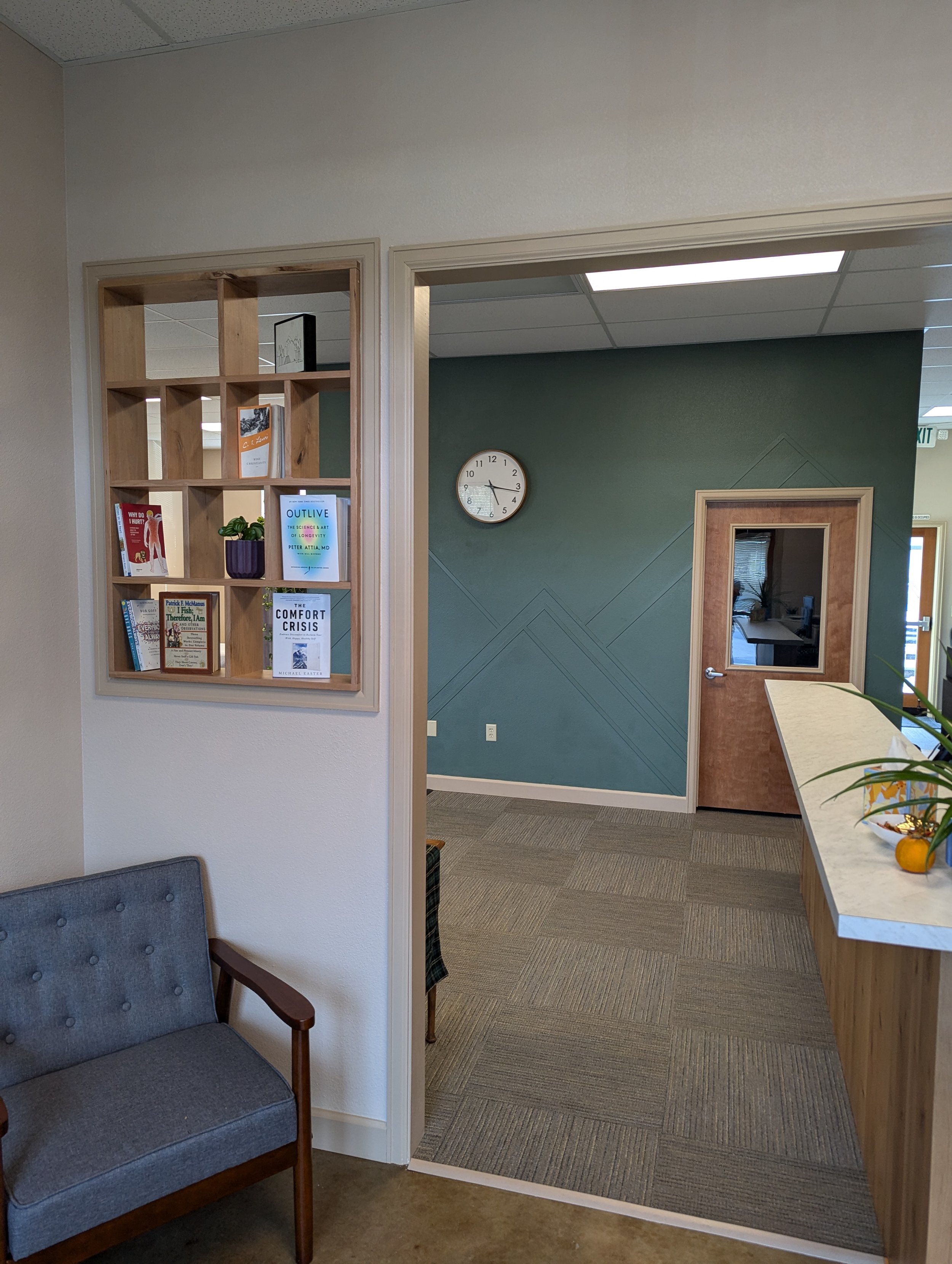 Office entry remodel in Boise Idaho with custom built-ins and modern interior finishes by commercial contractor