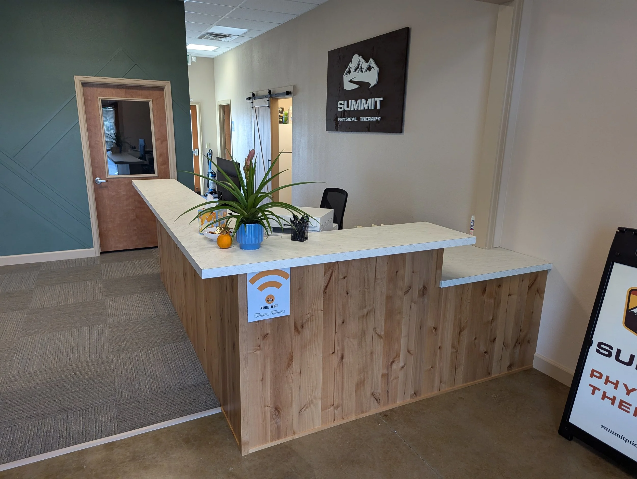 Commercial tenant improvement in Boise Idaho featuring custom reception desk and hallway layout by general contractor