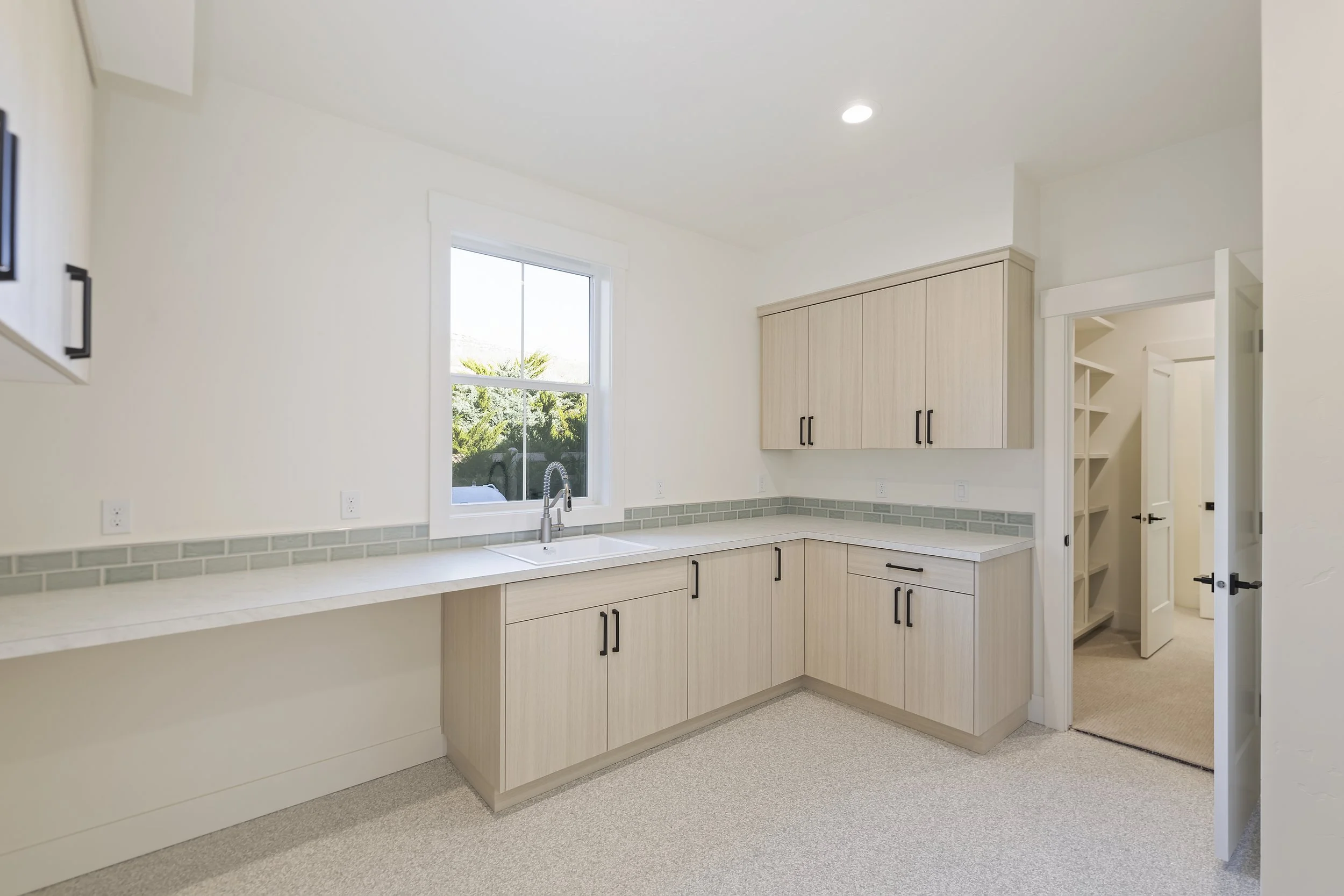 Custom laundry room Boise Idaho residential construction with built in cabinetry and modern finishes